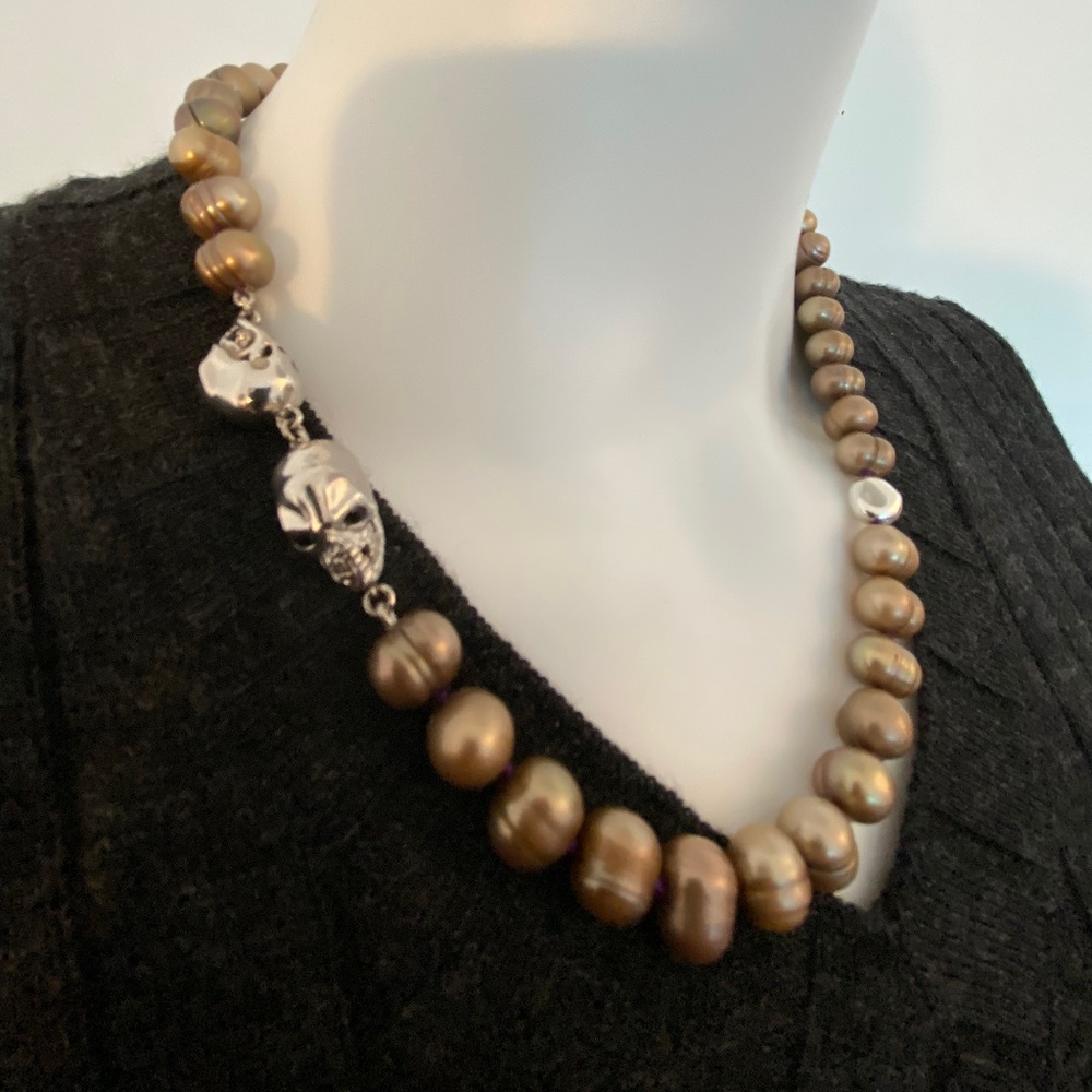 Real pearl necklace with sterling silver clasp, strung on a purple silk thread